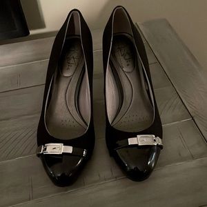 Black patent leather heels with silver buckle.  Only worn once.